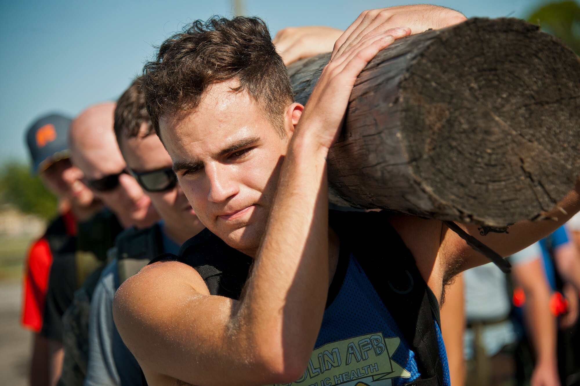 A team of participants prepare to carry a wooden log during the GoRuck team building challenge Sept. 24 at Eglin Air Force Base, Fla.  More than 45 participants pushed themselves through the physical scenarios led by a Special Forces veteran, to earn the blue and black “GoRuck” patch.  (U.S. Air Force photo/Samuel King Jr.)