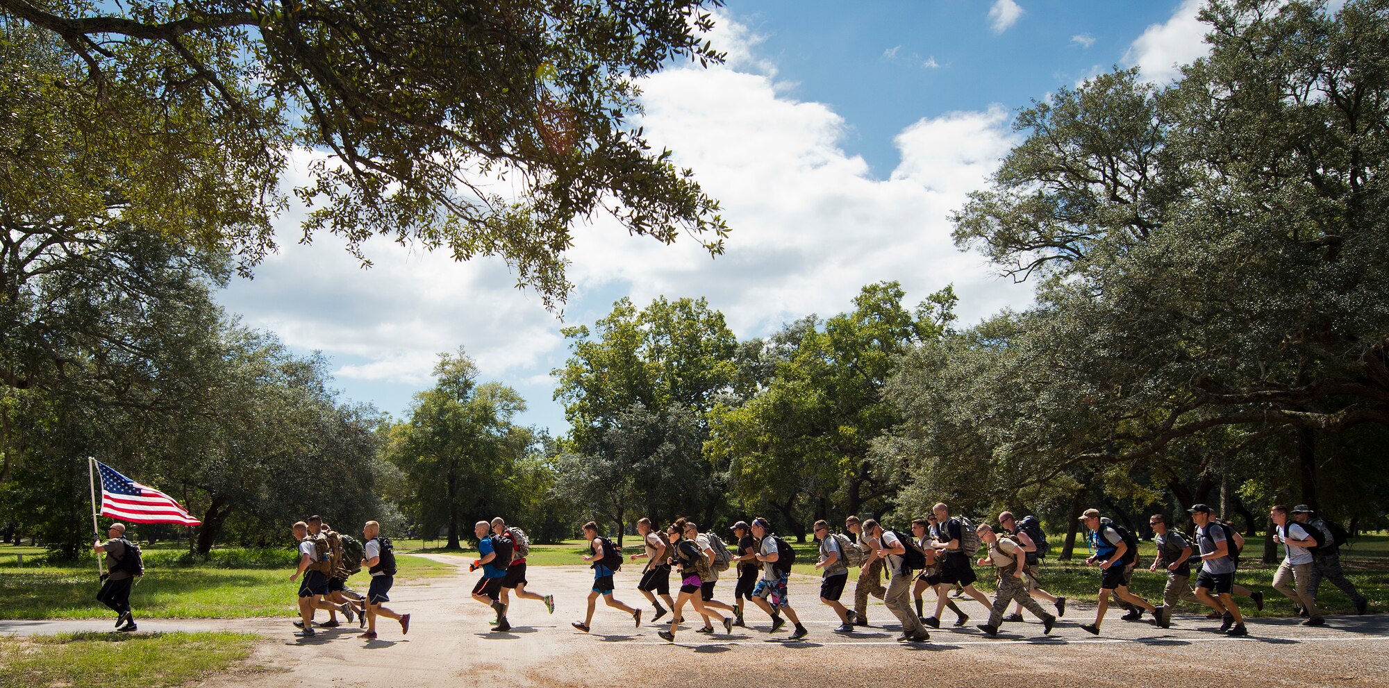 Participants begin to sprint, as a team, toward the end of the GoRuck team building challenge Sept. 24 at Eglin Air Force Base, Fla.  More than 45 participants pushed themselves through the physical scenarios led by a Special Forces veteran, to earn the blue and black “GoRuck” patch.  (U.S. Air Force photo/Samuel King Jr.)