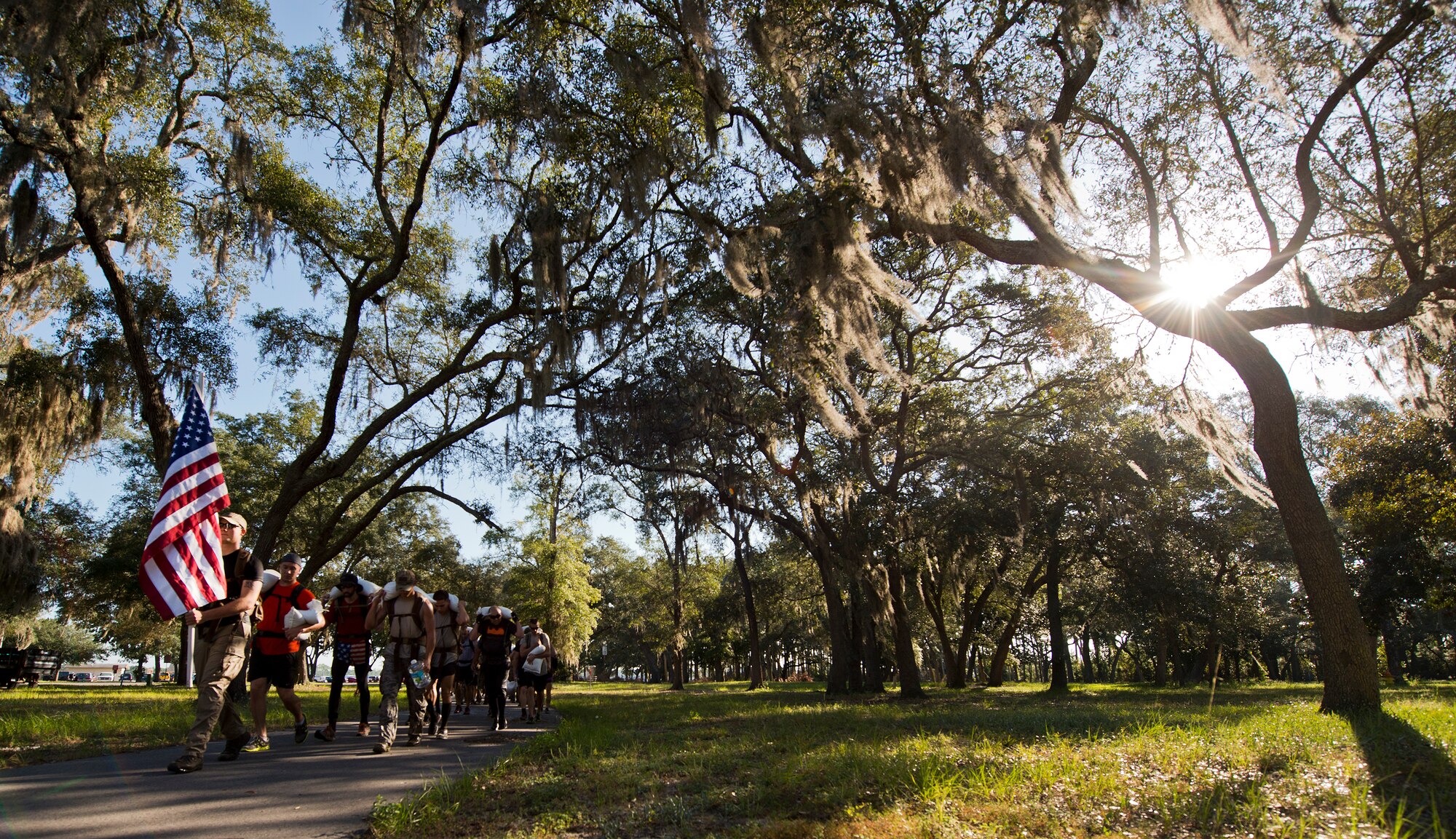 Participants begin the march from Post’l Point carrying rucksacks and sandbags Sept. 24 at the GoRuck team building challenge at Eglin Air Force Base, Fla.  More than 45 participants pushed themselves through the physical scenarios led by a Special Forces veteran, to earn the blue and black “GoRuck” patch.  (U.S. Air Force photo/Samuel King Jr.)