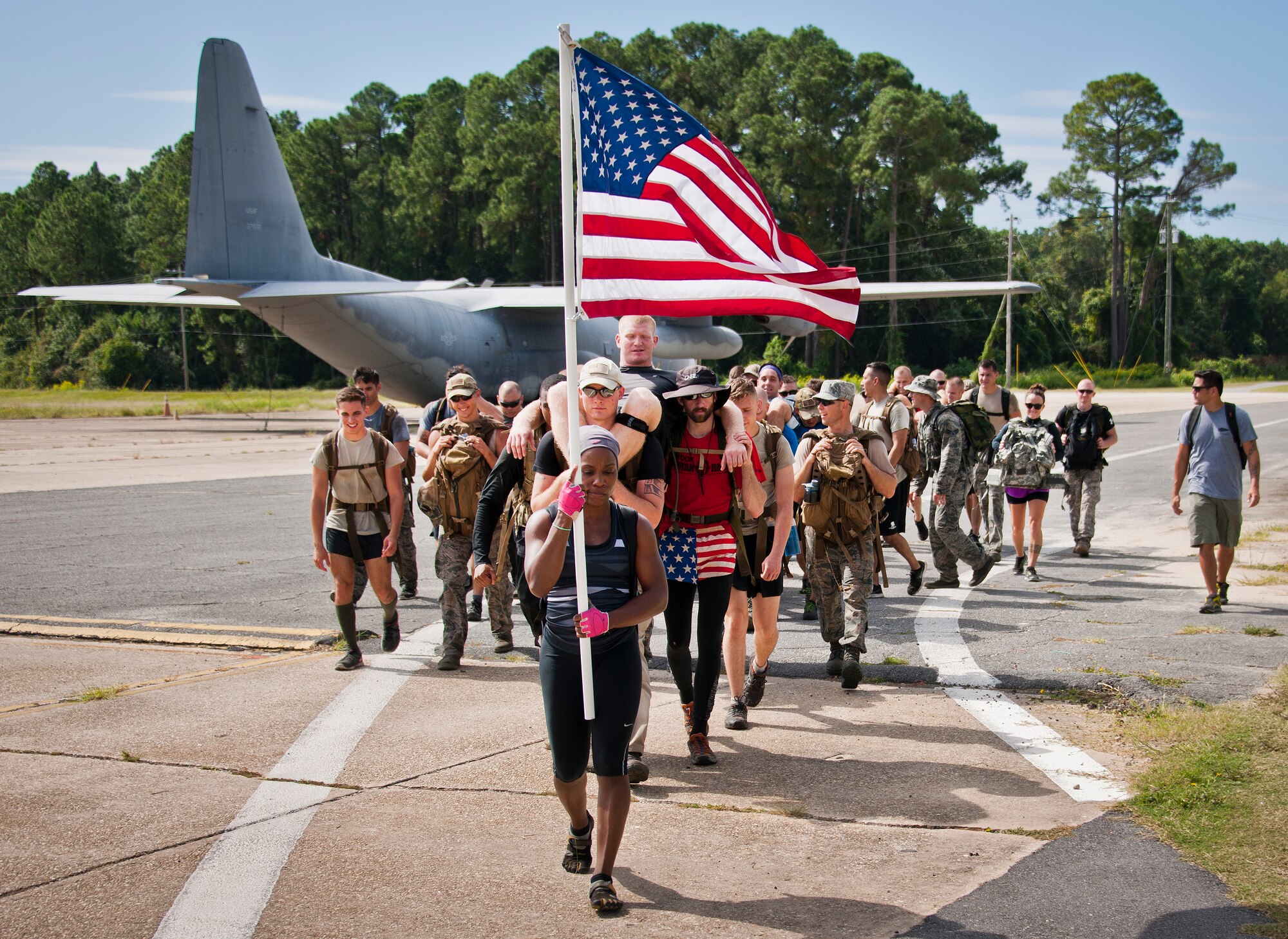 People carry their team members as simulated victims Sept. 24 during the GoRuck team building challenge at Eglin Air Force Base, Fla.  More than 45 participants pushed themselves through the physical scenarios led by a Special Forces veteran, to earn the blue and black “GoRuck” patch.  (U.S. Air Force photo/Samuel King Jr.)