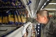 An Airman volunteers to help restock Commissary shelves on Sheppard Air Force Base, Texas, Sept. 27, 2015. This Airman, along with nearly 150 others, helped rescue nearly $200,000 worth of perishable items from a lighting strike that shut down the commissary power. (U.S. Air Force photo/Tech. Sgt. Mike Meares)