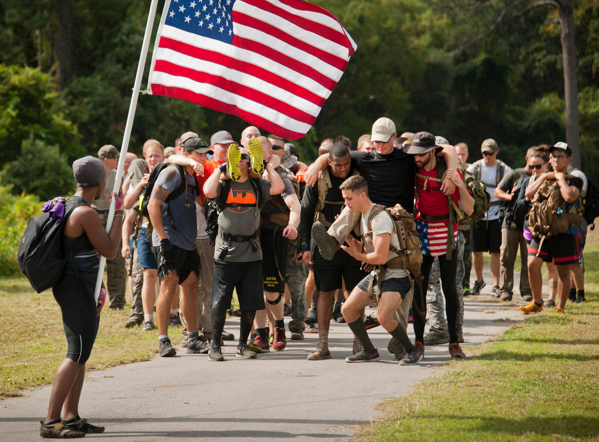 People lift their team members to carry them as simulated victims Sept. 24 during the GoRuck team building challenge at Eglin Air Force Base, Fla.  More than 45 participants pushed themselves through the physical scenarios led by a Special Forces veteran, to earn the blue and black “GoRuck” patch.  (U.S. Air Force photo/Samuel King Jr.) 