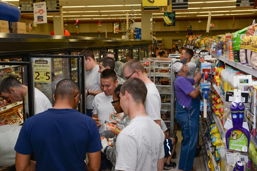 Airmen from Sheppard Air Force Base, Texas, volunteer to restock the commissary shelves after rescuing perishable foods from a power outage, Sept. 27, 2015. The power outage was caused by lightning that struck a transformer, shutting down the power to the building. The Airmen helped to rescue nearly $200,000 worth of perishable items. (U.S. Air Force photo/Senior Airman Kyle Gese)