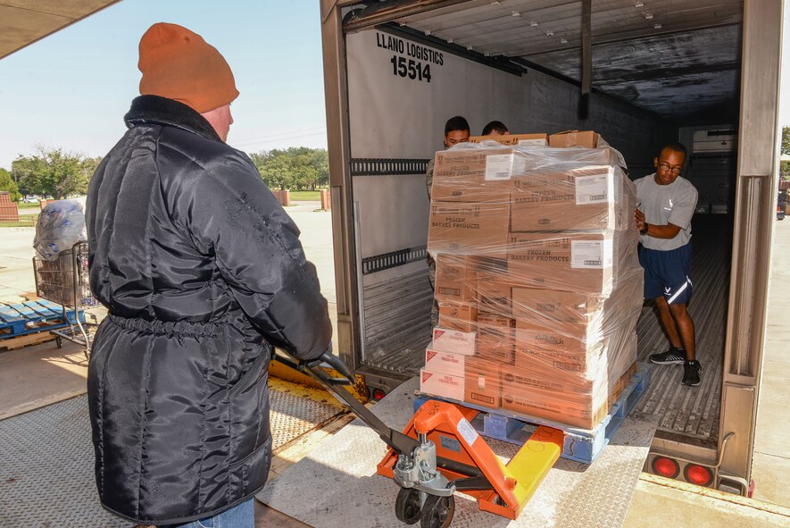 Airmen from Sheppard Air Force Base, Texas, volunteer to help rescue perishable foods from the base commissary, Sept. 27, 2015. Lightning struck a transformer the night prior that cut off the power to the commissary refrigerators, putting the perishable items at risk for spoiling. The volunteers helped bring the food to other base facilities with refrigeration capabilities to eliminate the risk of spoiling. (U.S. Air Force photo/Senior Airman Kyle Gese)