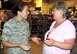 1st Lt. Chawntel Vega of the 82nd Medical Group's Public Health Flight talks with Commissary Director Donna Romolton as volunteers help rescue perishable foods from the base commissary, Sept. 27, 2015. Lightning struck a transformer the night prior that cut off the power to the commissary refrigerators, putting the perishable items at risk for spoiling. Public Health worked with the team to ensure food safety throughout the effort, screening all food at least three times to ensure proper temperatures were maintained. (U.S. Air Force photo/George Woodward)
