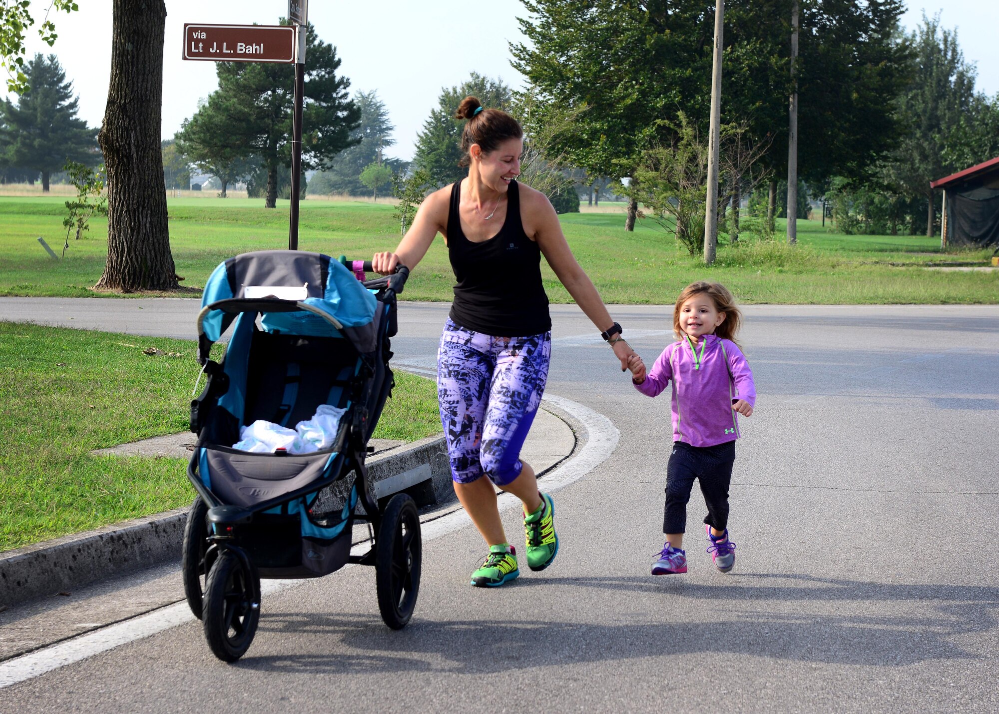 Trisha Piazza and her daughter Sofia approach the finish line during the 10k portion of Team Aviano’s 9th annual Aviano Half Marathon, Sept. 9, 2015. Runners received a participation medal and the top three male and female finishers were recognized. (U.S. Air Force photo by Senior Airman Areca T. Bell/Released)
