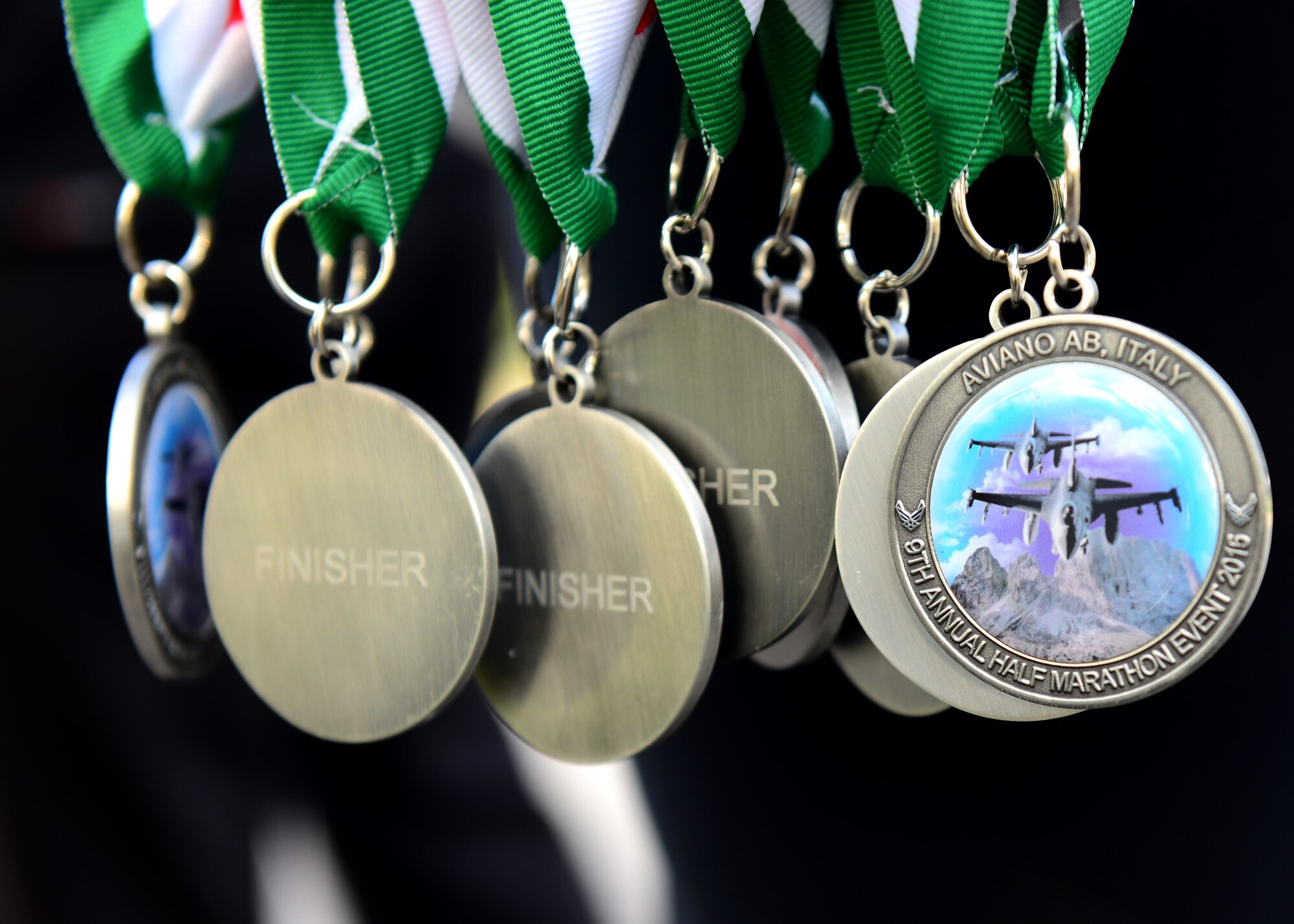 Finisher medals are given to participants at the end of Team Aviano’s 9th annual Aviano Half Marathon, Sept. 9, 2015. Runners received a participation medal and the top three male and female finishers were recognized. (U.S. Air Force photo by Senior Airman Areca T. Bell/Released)