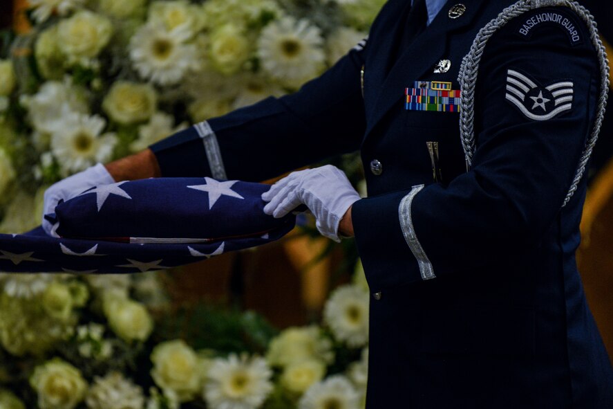 A Ramstein Air Base honor guardsmen folds the U.S. flag during a POW/MIA wreath-laying ceremony Sept. 16, 2015, at Ramstein Air Base, Germany.  After the folding of the flag, retired U.S. Air Force Col. Joseph Milligan spoke about his experiences as a prisoner of war. (U.S. Air Force photo/Senior Airman Nicole Sikorski)
