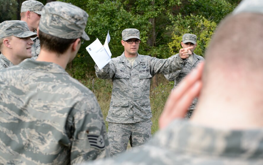 Tech. Sgt. Benjamin Hall, 7th Weather Squadron battlefield weather Airman, conducts a post-exercise briefing after 7th WS Airmen completed a land navigation course Sept. 16, 2015, at Grafenwohr Training Area, Germany.  Land navigation was one of many skills covered by instructors during Cadre Focus,  an exercise designed to improve the services the 7th WS provides to Army units throughout Europe. (U.S. Air Force photo/Staff Sgt. Armando A. Schwier-Morales)