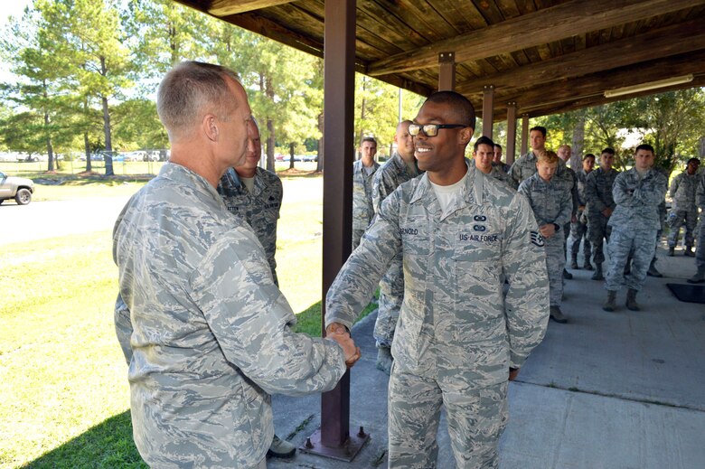 U.S. Air Force Maj. Gen. Mark Kelly, 9th Air Force commander, presents his commander’s coin to Staff Sgt. Deron Arnold, a procedural controller assigned to the 682nd Air Support Operations Squadron, recognizing his outstanding duty performance. Kelly visited 18th Air Support Operations Group battlefield Airmen at Pope Army Airfield, North Carolina, Sept. 14, 2015. (U.S. Air Force photo/Marvin Krause)