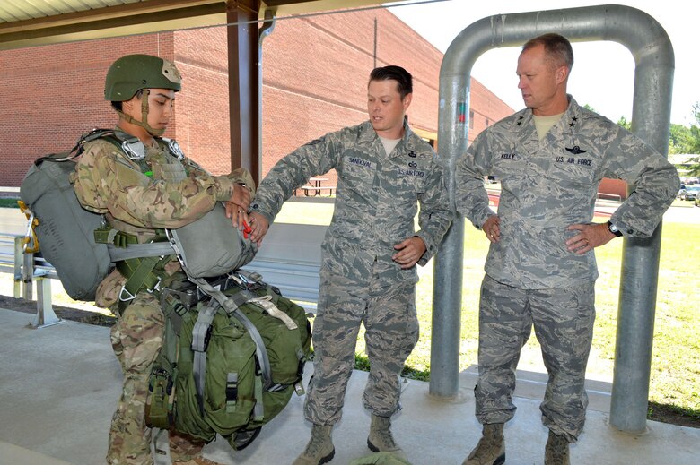 U.S. Air Force Staff Sgt. Jason Sandoval, a tactical air control party specialist assigned to the 14th Air Support Operations Squadron, briefs Maj. Gen. Mark Kelly, 9th Air Force commander, about tactical air control party equipment worn by Airman 1st Class Paul Rebultan, a tactical air control party specialist also assigned to the 14th ASOS. Kelly visited 18th Air Support Operations Group battlefield Airmen at Pope Army Airfield, North Carolina, Sept. 14, 2015. (U.S. Air Force photo/Marvin Krause)