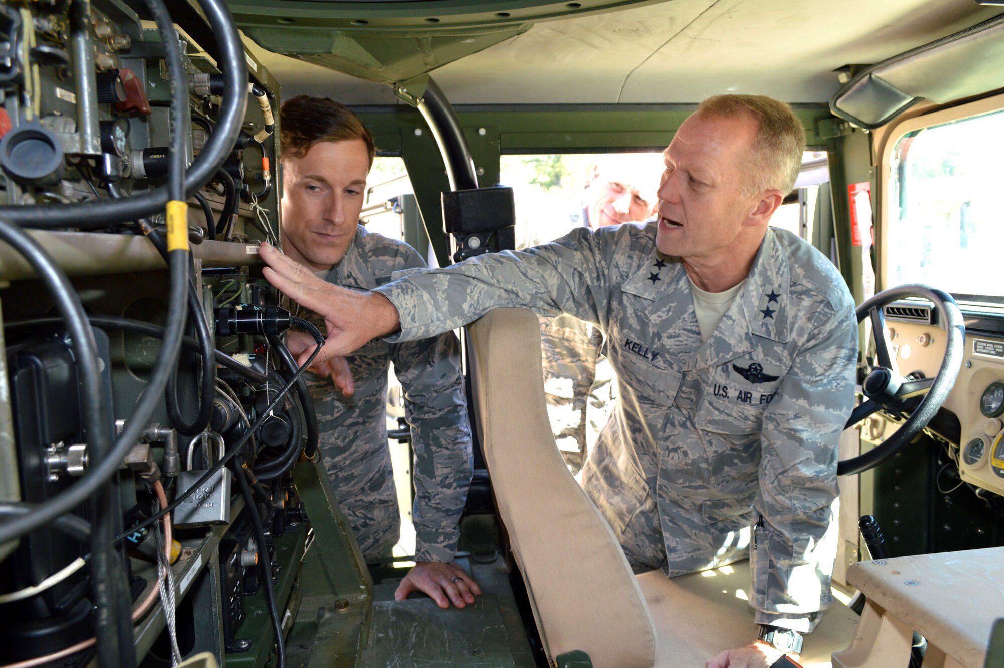 U.S. Air Force Staff Sgt. James Demars II, a tactical air control party specialist assigned to the 14th Air Support Operations Squadron, briefs Maj. Gen. Mark Kelly, 9th Air Force commander, about tactical communications equipment mounted in a High Mobility Multipurpose Wheeled Vehicle. Kelly visited 18th Air Support Operations Group battlefield Airmen at Pope Army Airfield, North Carolina, Sept. 14, 2015. (U.S. Air Force photo/Marvin Krause)