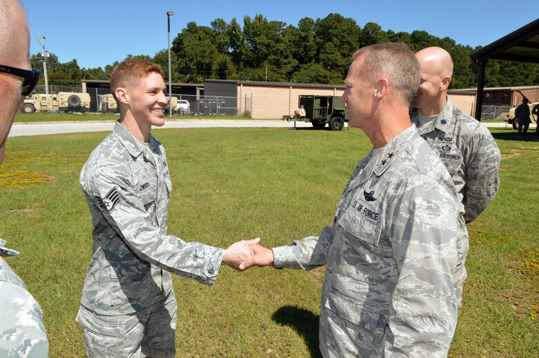 U.S. Air Force Maj. Gen. Mark Kelly, 9th Air Force commander, presents his commander’s coin to Staff Sgt. Brian Zwiers, a battlefield weather forecaster assigned to the 18th Weather Squadron, recognizing his outstanding duty performance. Kelly visited 18th Air Support Operations Group battlefield Airmen at Pope Army Airfield, North Carolina, Sept. 14, 2015. (U.S. Air Force photo/Marvin Krause)