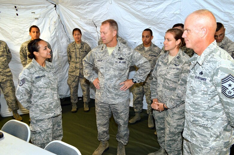 U.S. Air Force Staff Sgt. Justina Gonzalez, an intelligence specialist assigned to the 682nd Air Support Operations Squadron, provides a mission briefing to Maj. Gen. Mark Kelly, 9th Air Force commander, and Command Chief Master Sgt. Frank Batten III, 9th Air Force command chief, on air support operations center operations and how she manages the battlefield threat picture to ensure the safety of blue forces on the ground. Kelly and Batten visited 18th Air Support Operations Group battlefield Airmen at Pope Army Airfield, North Carolina, Sept. 14, 2015. (U.S. Air Force photo/Marvin Krause)