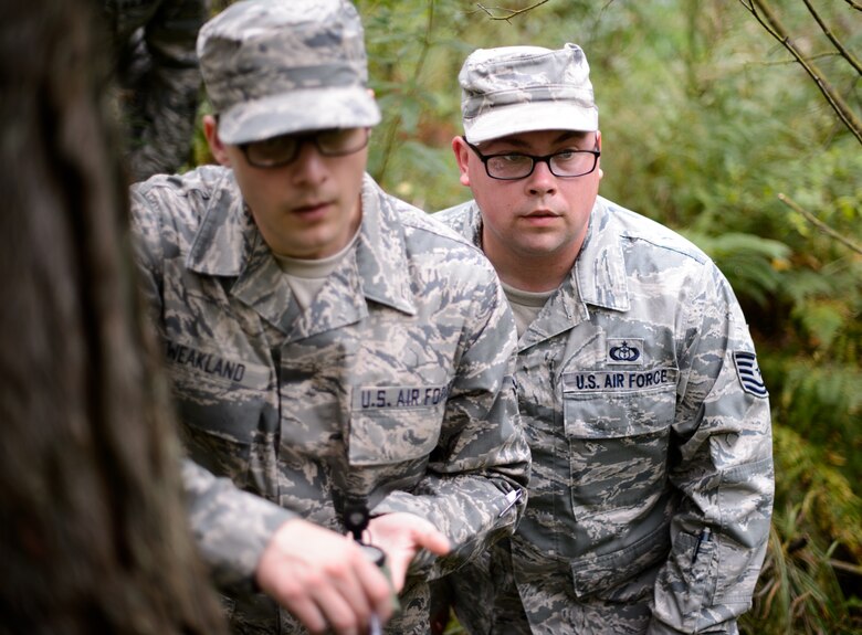 Staff Sgt. Cody Weakland and Tech. Sgt. Joshua Wisnewski, both 7th Weather Squadron battlefield weather Airmen, search for a fixed location in the woods of Grafenwohr Training Area, Germany, Sept. 16, 2015. The Airmen participated in Cadre Focus along with 30 other battlefield weather Airmen to enhance their skills and abilities in order to better support Army units. (U.S. Air Force photo/Staff Sgt. Armando A. Schwier-Morales)