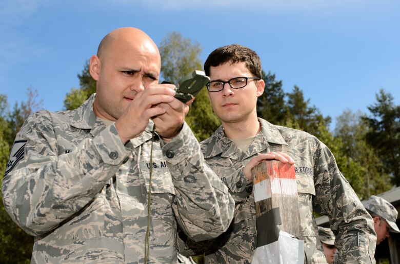 Master Sgt. Steven Hollatz, 7th Weather Squadron logistics and resources NCO in charge, left, and Staff Sgt. Cody Weakland, 7th WS battlefield weather Airman, ensure the accuracy of their compass during an annual training exercise known as Cadre Focus Sept. 16, 2015, at Grafenwohr Training Area, Germany. Approximately 30 Airmen took part in Cadre Focus, an exercise designed to improve forecasting and Army skills such as land navigation and group movements. (U.S. Air Force photo/Staff Sgt. Armando A. Schwier-Morales)