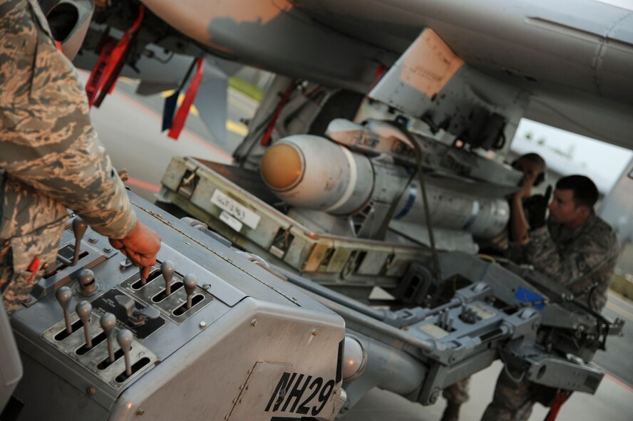 74th Expeditionary Fighter Squadron weapons load crew team work together to load a Training Guided Missile on a U.S. Air Force A-10 Thunderbolt II attack aircraft prior to the first training mission at Amari Air Base, Estonia, Sept. 23, 2015. This is the first deployment for each member of this three-person crew who are deployed from the 23rd Wing at Moody Air Force Base, Georgia.