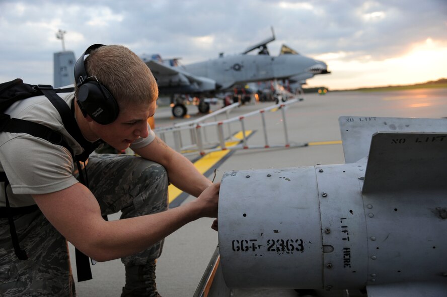 U.S. Air Force Airman 1st Class Austin Kobus, 74th Expeditionary Fighter Squadron weapons load crew member, removes the grounding strap from a Training Guided Missile to prepare for munition loading prior to the first A-10 Thunderbolt II attack aircraft  sortie during a Theater Security Package deployment at Amari Air Base, Estonia, Sept. 23, 2015. As a weapons load crew member, Kobus is responsible for preparing the munitions for loading. (U.S. Air Force photo by Andrea Jenkins/Released)