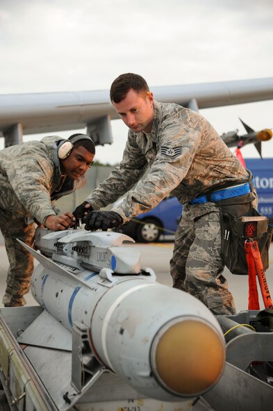 Staff Sgt. Josh Stephenson, 74th Expeditionary Fighter Squadron weapons load crew team chief, and Airman 1st Class Malik Ware, 74th EFS weapons load crew member prepare to load a Training Guided Missile on a U.S. Air Force A-10 Thunderbolt II attack aircraft prior to the first training mission at Amari Air Base, Estonia, Sept. 23, 2015. Prior to each training mission, the weapons Airmen are responsible for reconfiguring the 12 A-10s that are deployed from the 23rd Wing at Moody Air Force Base, Georgia, as part of a Theater Security Package in support of Operation Atlantic Resolve. (U.S. Air Force photo by Andrea Jenkins/Released)