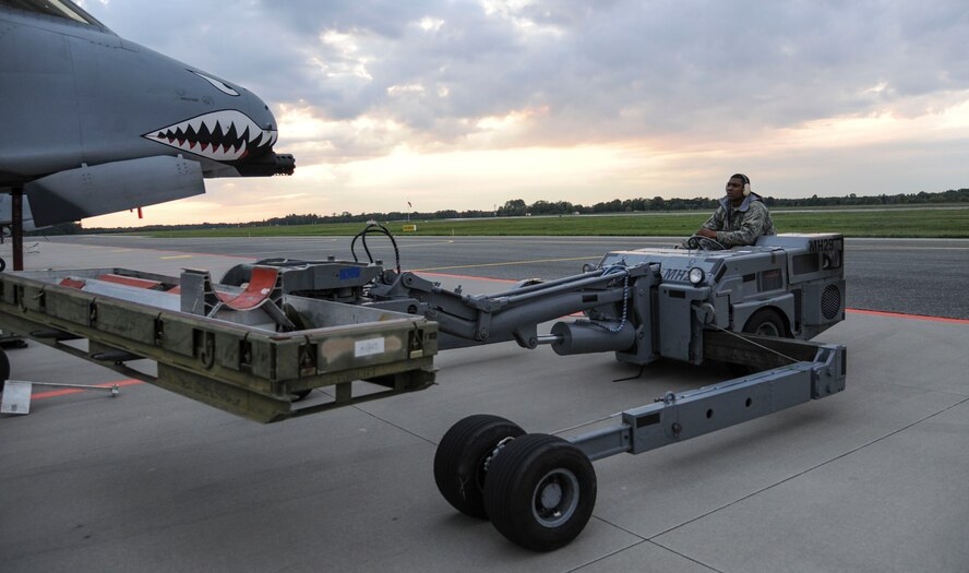 U.S. Air Force Airman 1st Class Malik Ware, 74th Expeditionary Fighter Squadron weapons load crew member, backs up a jammer after  loading a Training  Guided Missile onto an A-10 Thunderbolt II attack aircraft, in preparation for the first sortie flown during a Theater Security Package deployment at Amari Air Base, Estonia, Sept. 23, 2015. As a weapons load crew member, Ware is responsible for preparing the munitions prior to loading on the aircraft. (U.S. Air Force photo by Andrea Jenkins/Released)