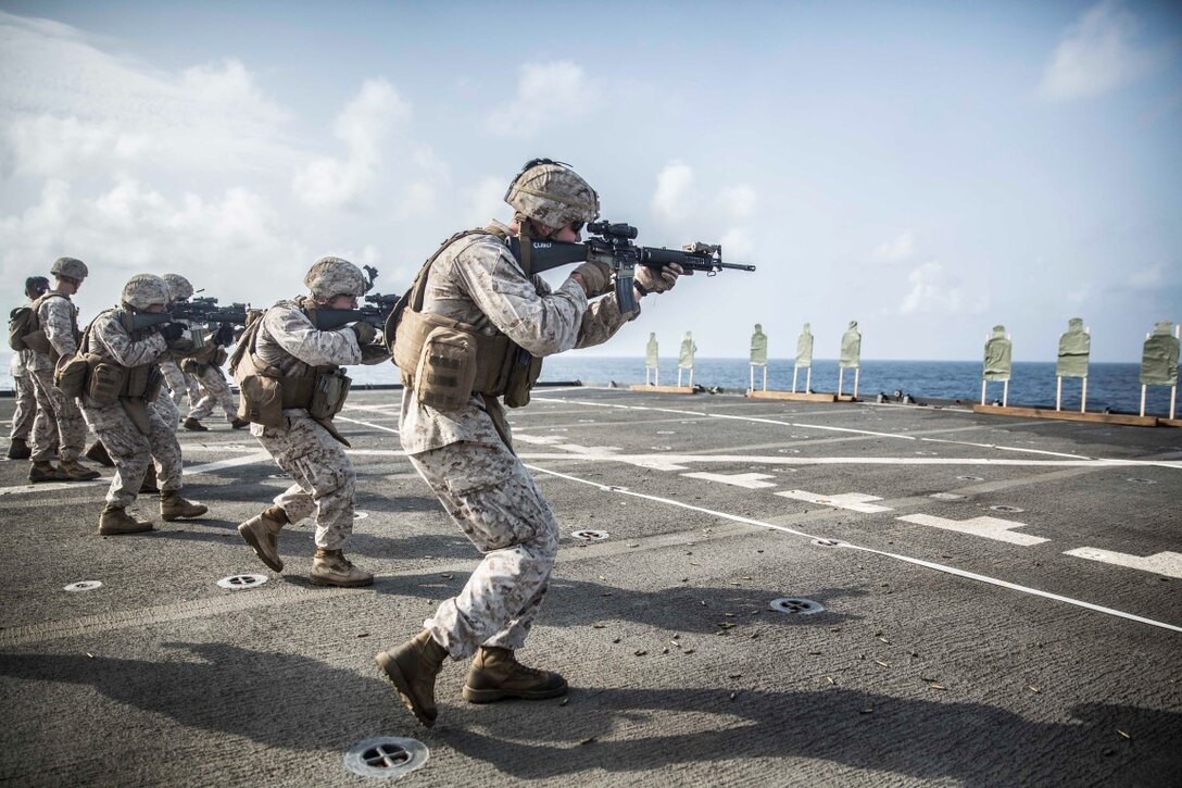 INDIAN OCEAN (Sept. 22, 2015) U.S. Marines with Kilo Company, Battalion Landing Team 3rd Battalion, 1st Marine Regiment, 15th Marine Expeditionary Unit, sharpen their weapons handling skills during a marksmanship qualification course aboard the dock landing ship USS Rushmore (LSD 47). The marksmanship course focused on retaining basic marksmanship skills which prepares them for potential operations while deployed with the 15th MEU. The 15th MEU, embarked aboard the ships of the Essex Amphibious Ready Group, is deployed to maintain regional security in the U.S. 5th Fleet area of operations. (U.S. Marine Corps photo by Sgt. Emmanuel Ramos/Released)