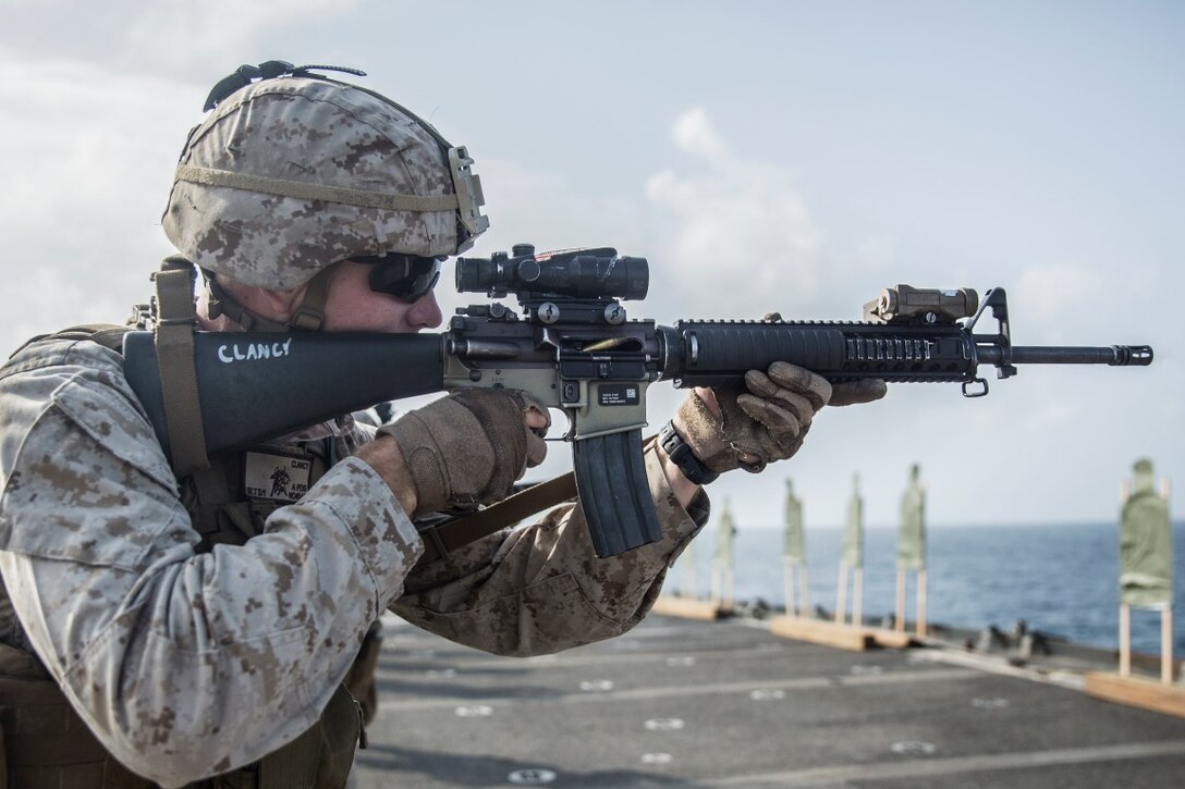 INDIAN OCEAN (Sept. 22, 2015) U.S. Marine Lance Cpl. Nicholas Clancy fires at his target during a marksmanship qualification course aboard the dock landing ship USS Rushmore (LSD 47). Clancy is an automatic machine gunner with Kilo Company, Battalion Landing Team 3rd Battalion, 1st Marine Regiment, 15th Marine Expeditionary Unit. The marksmanship course focused on retaining basic marksmanship skills which prepares them for potential operations while deployed with the 15th MEU. The 15th MEU, embarked aboard the ships of the Essex Amphibious Ready Group, is deployed to maintain regional security in the U.S. 5th Fleet area of operations. (U.S. Marine Corps photo by Sgt. Emmanuel Ramos/Released)
