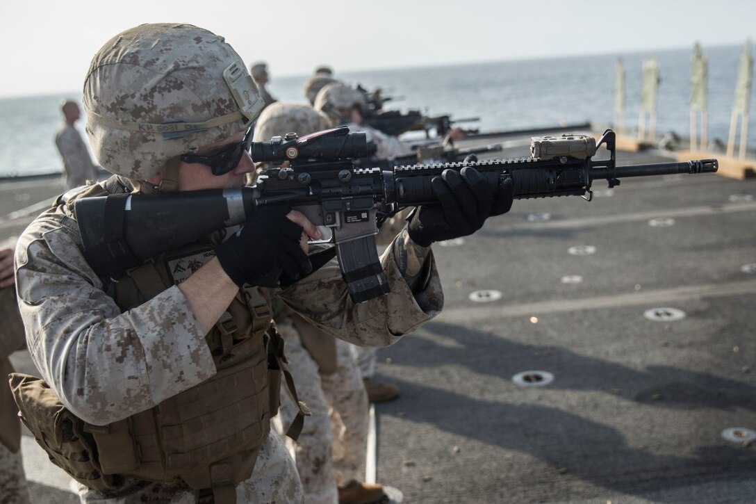 INDIAN OCEAN (Sept. 22, 2015) U.S. Marine Lance Cpl. Cody Hoag engages his target during a marksmanship qualification course aboard the dock landing ship USS Rushmore (LSD 47). Hoag is a rifleman with Kilo Company, Battalion Landing Team 3rd Battalion, 1st Marine Regiment, 15th Marine Expeditionary Unit. The marksmanship course focused on retaining basic marksmanship skills which prepares them for potential operations while deployed with the 15th MEU. The 15th MEU, embarked aboard the ships of the Essex Amphibious Ready Group, is deployed to maintain regional security in the U.S. 5th Fleet area of operations. (U.S. Marine Corps photo by Sgt. Emmanuel Ramos/Released)