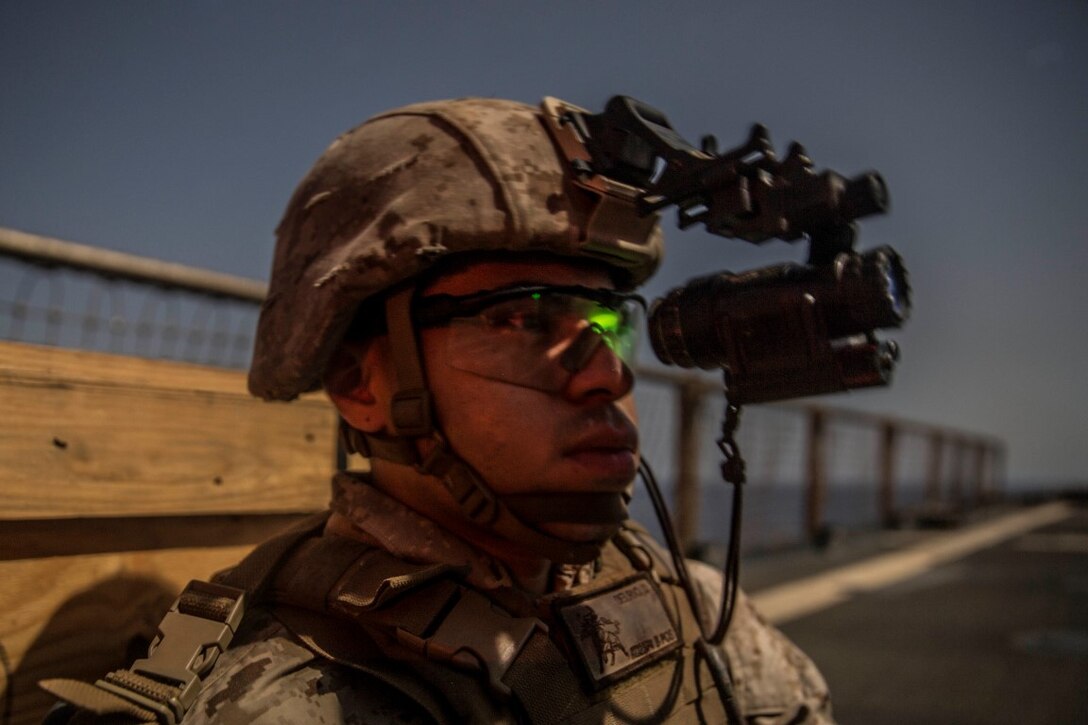 INDIAN OCEAN (Sept. 24, 2015) U.S. Marine Lance Cpl. Daniel Del Rio waits for his rely to be called during a marksmanship qualification course aboard the dock landing ship USS Rushmore (LSD 47). Del Rio is a rifleman with Kilo Company, Battalion Landing Team 3rd Battalion, 1st Marine Regiment, 15th Marine Expeditionary Unit. The marksmanship course focused on sharpening basic marksmanship skills under the cover of darkness which prepares them for potential operations while deployed with the 15th MEU. The 15th MEU, embarked aboard the ships of the Essex Amphibious Ready Group, is deployed to maintain regional security in the U.S. 5th Fleet area of operations. (U.S. Marine Corps photo by Sgt. Emmanuel Ramos/Released)