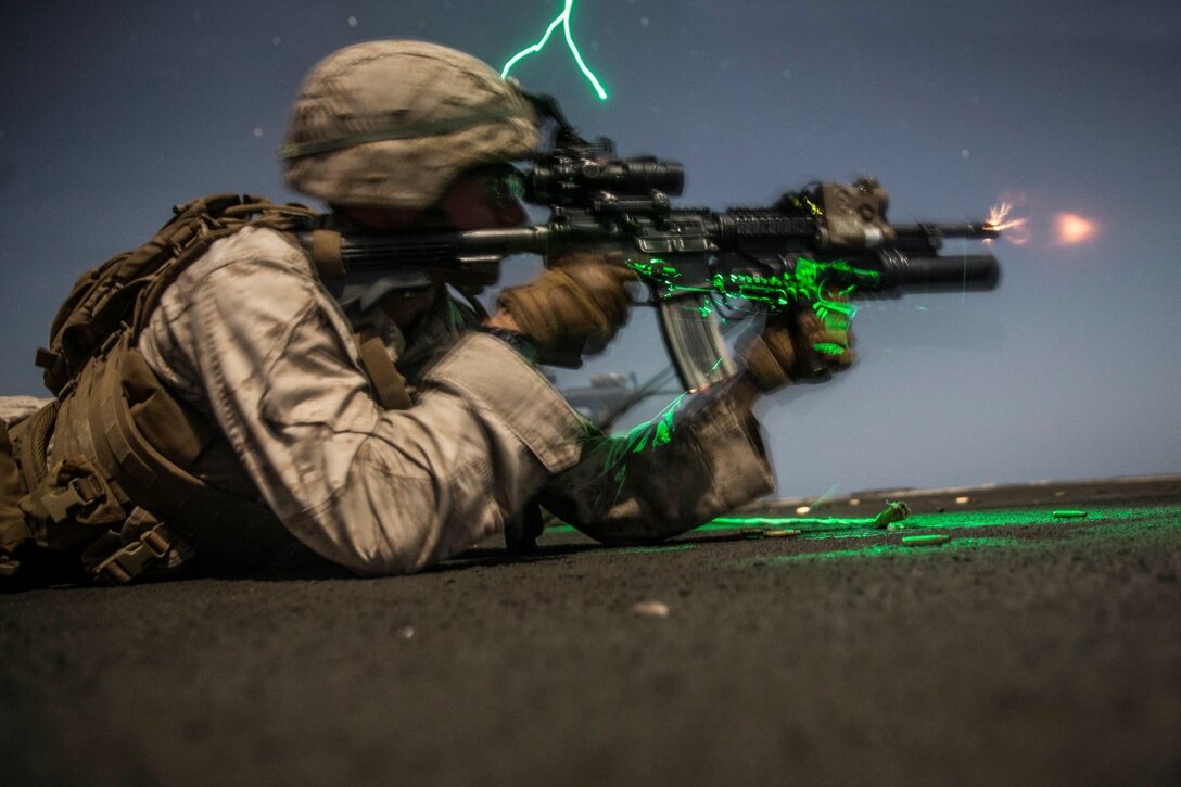 INDIAN OCEAN (Sept. 24, 2015) U.S. Marine Lance Cpl. Steven Knapp fires at his target during a marksmanship qualification course aboard the dock landing ship USS Rushmore (LSD 47). Knapp is a team leader with Kilo Company, Battalion Landing Team 3rd Battalion, 1st Marine Regiment, 15th Marine Expeditionary Unit. The marksmanship course focused on sharpening basic marksmanship skills under the cover of darkness which prepares them for potential operations while deployed with the 15th MEU. The 15th MEU, embarked aboard the ships of the Essex Amphibious Ready Group, is deployed to maintain regional security in the U.S. 5th Fleet area of operations. (U.S. Marine Corps photo by Sgt. Emmanuel Ramos/Released)