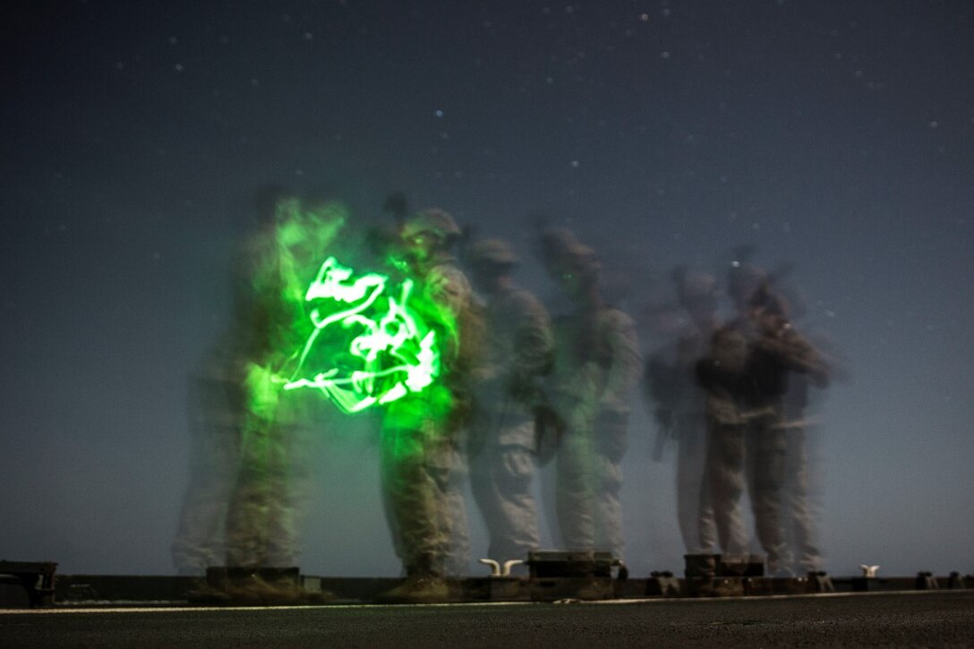 INDIAN OCEAN (Sept. 24, 2015) U.S. Marines with Kilo Company, Battalion Landing Team 3rd Battalion, 1st Marine Regiment, 15th Marine Expeditionary Unit, ensure their weapons are clear of any ammunition during a marksmanship qualification course aboard the dock landing ship USS Rushmore (LSD 47). The marksmanship course focused on sharpening basic marksmanship skills under the cover of darkness which prepares them for potential operations while deployed with the 15th MEU. The 15th MEU, embarked aboard the ships of the Essex Amphibious Ready Group, is deployed to maintain regional security in the U.S. 5th Fleet area of operations. (U.S. Marine Corps photo by Sgt. Emmanuel Ramos/Released)