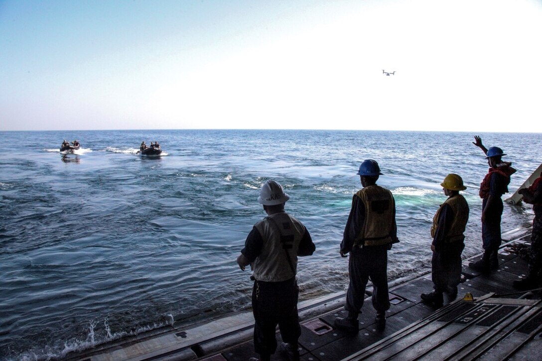 ARABIAN GULF (Sept. 26, 2015) U.S. Marines with the 15th Marine Expeditionary Unit’s Maritime Raid Force depart in combat rubber raiding craft from the well deck of the amphibious assault ship USS Essex (LHD 2). The MRF tested the engines of their CRRC’s in order to maintain combat readiness. The 15th MEU, embarked aboard the ships of the Essex Amphibious Ready Group, is deployed to maintain regional security in the U.S. 5th Fleet area of operations. (U.S. Marine Corps photo by Cpl. Elize McKelvey/Released)