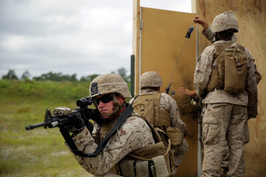 A Marine provides security as Marines in his platoon set up an urban charge on a door during a demolitions exercise on Camp Lejeune, N.C., Sept. 22, 2015. The Marine is a combat engineer assigned to the 2nd Battalion, 2nd Marine Regiment, which conducted the training to increase their proficiency and knowledge with various charges and techniques. U. S. Marine Corps photo by Cpl. Alexander Mitchell