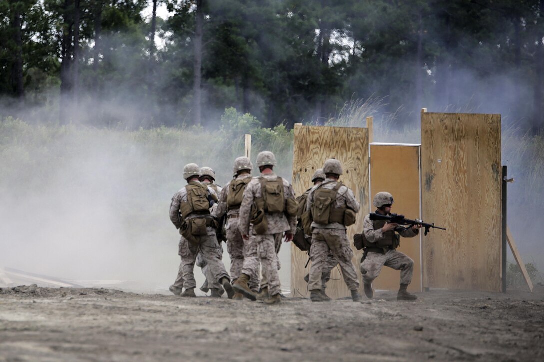 Marines rush into a breached door after an urban charge detonation during a demolitions exercise on Camp Lejeune, N.C., Sept. 22, 2015. U.S. Marine Corps photo by Cpl. Alexander Mitchell