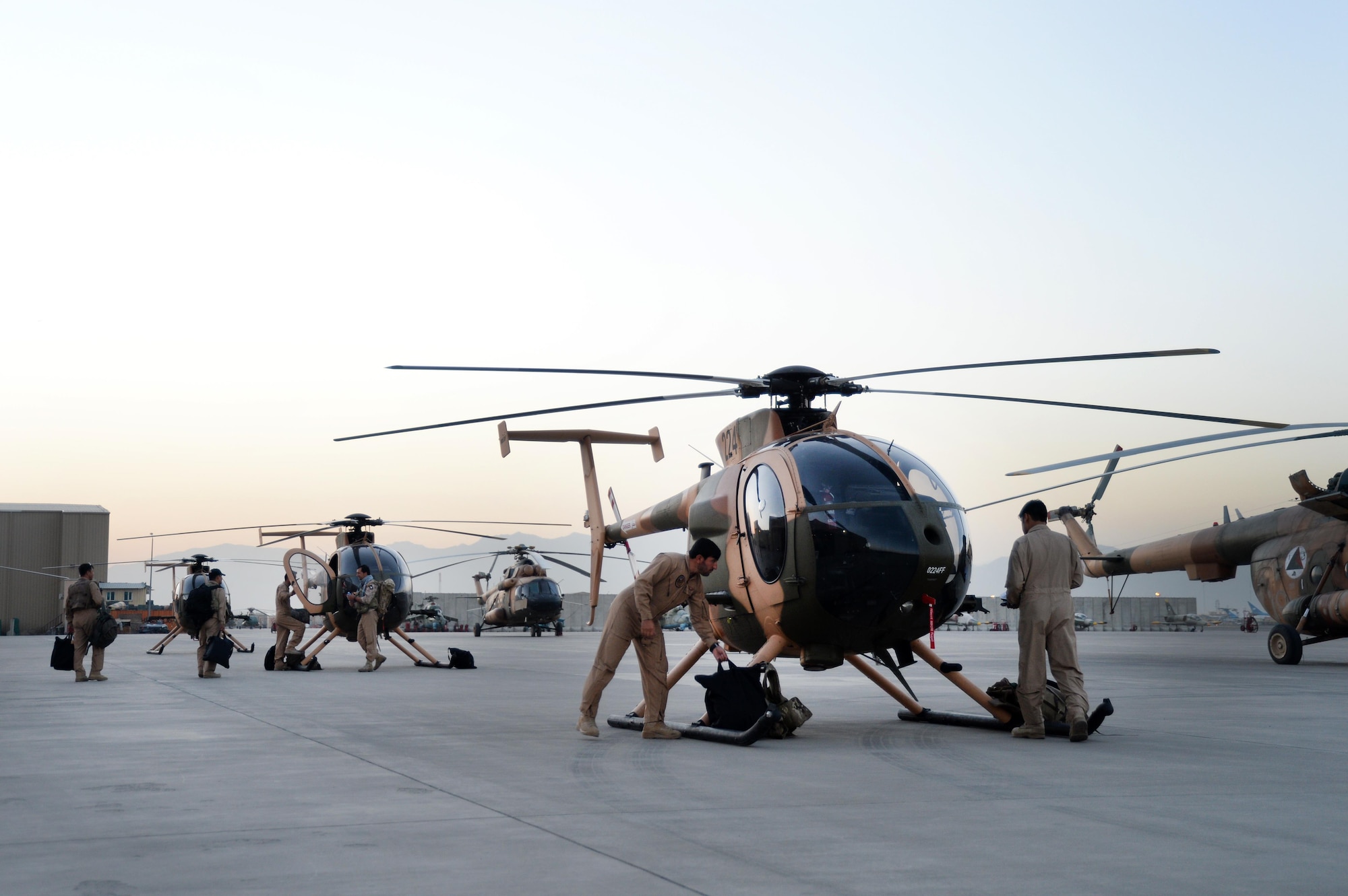 Afghan Air Force pilots perform pre-flight inspections prior to an all-Afghan combat mission. The crews flew out of Hamid Karzai International Airport, Kabul, Afghanistan, Sept. 27, 2015. (U.S. Air Force photo by Staff Sgt. Sandra Welch/released)