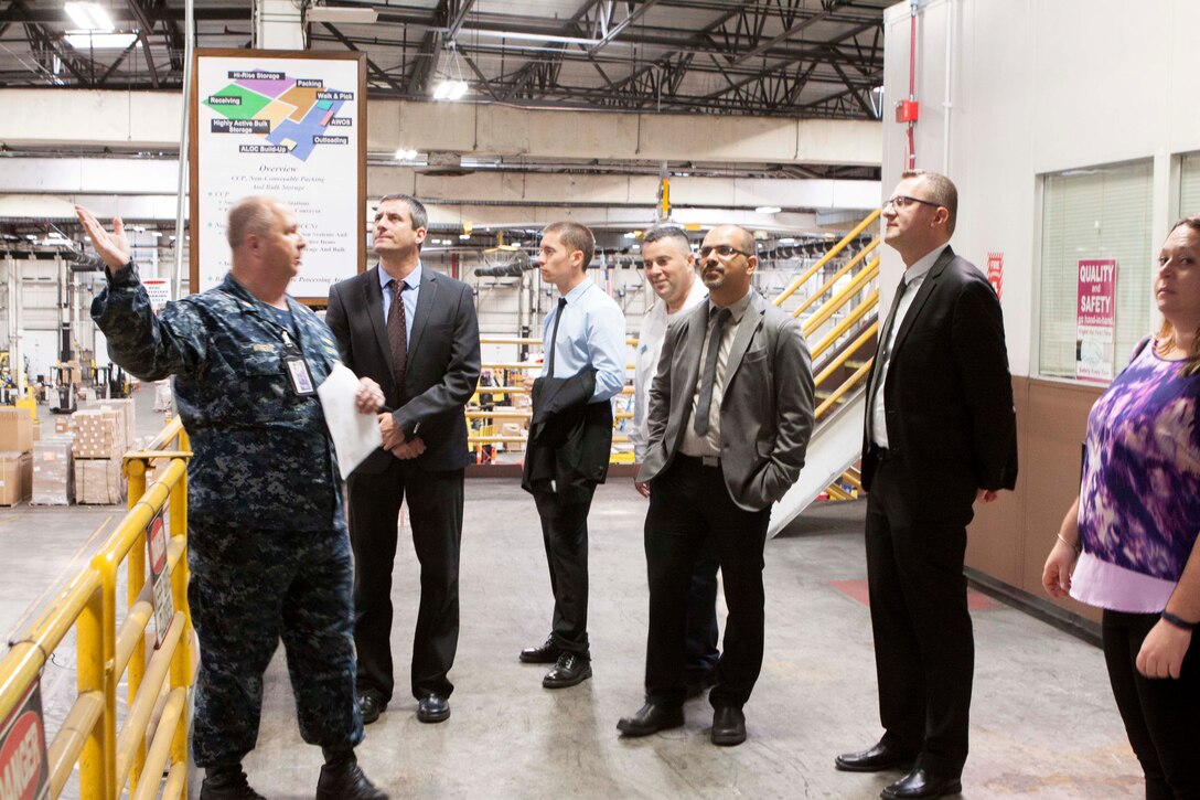 U.S. Navy Lt. Cmdr. David Wright, left, DLA Distribution Susquehanna, explains DLA Distribution Susquehanna’s processes at the Consolidation and Containerization Point during the Israeli Navy’s visit on July 16. 