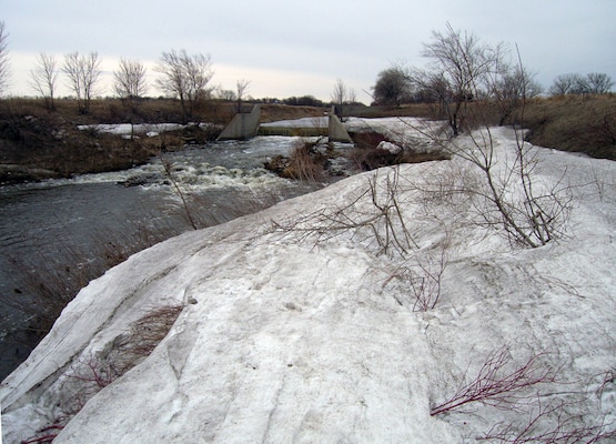 A major reach of the Sand Hill River downstream of Fertile, Minn., was the subject of a flood control project constructed by the Corps of Engineers from 1955 to 1958. It involved straightening the river and constructing four drop structures and served as a drainage improvement to local agriculture. Overall, more than 18 miles of the Sand Hill River was straightened or abandoned. The straightened channel decreased channel length, increased channel grade, increased channel conveyance, and reduced the flood profiles in the lower Sand Hill River watershed. A series of four concrete drop structures were installed in the new Sand Hill River alignment to provide grade control. These grade control structures created six to eight-foot changes in bed grade, but left the river itself impassable for spawning fish.  

A preliminary restoration plan completed in 2003 recommended several measures to improve fish passage in the river including construction of rock structures at each of the Corps drop structures in the river as well as installation of several riffles and pools to decrease the slope of the river and create areas for refuge and rest for migrating fish.