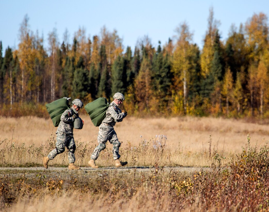 Soldiers proceed to the rally point after conducting a helicopter jump on Malemute drop zone, Joint Base Elmendorf-Richardson, Alaska, Sept. 24, 2015. U.S. Air Force photo by Alejandro Pena 