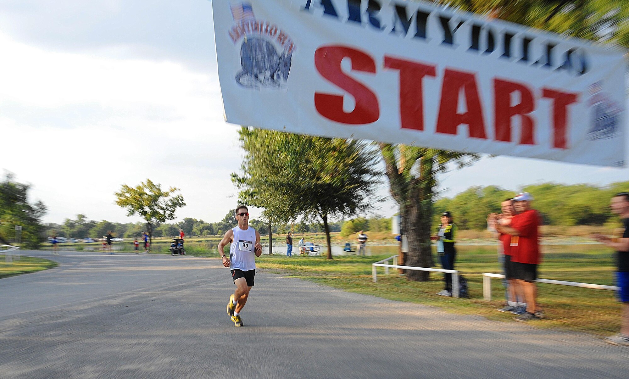 U.S. Army Maj. Jason Tullius, 344th Military Intelligence Battalion executive officer, races across the finish line for the 21st Annual Armydillo Run in San Angelo, Texas, Sept. 26, 2015. Tullius was the first participant to finish the 10 K at a winning time of 40 minutes and 54 seconds. (U.S. Air Force photo by Airman Caelynn Ferguson/Released)