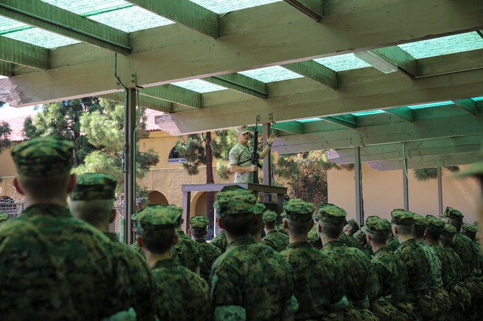 Chief Warrant Officer William Tinney, ordinance officer, Marine Corps Recruit Depot San Diego, instructs recruits of Alpha Company, 1st Recruit Training Battalion, on how to properly hold the M16-A4 Service Rifle during rifle issue at Marine Corps Recruit Depot San Diego, Calif., Sept. 18. Today, all males recruited west of the Mississippi are trained at MCRD San Diego. The depot is responsible for training more than 16,000 recruits annually. Alpha Company is scheduled to graduate from recruit training on Dec. 18.
