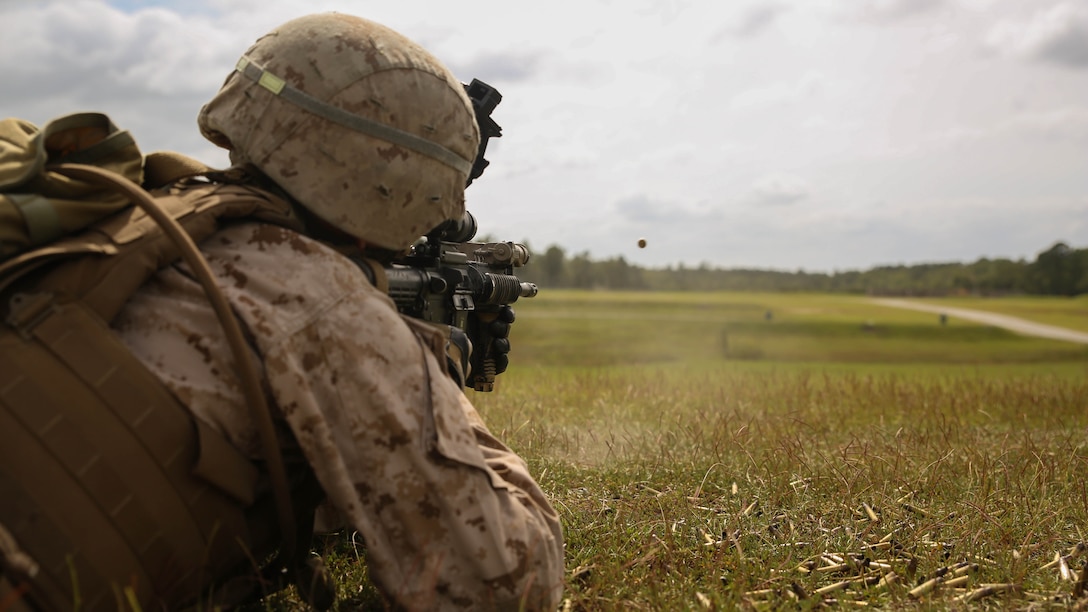 A Marine with 1st Battalion, 6th Marine Regiment takes aim, using a M4 carbine and fires rounds at a practice target during live fire training aboard Camp Lejeune N.C., Sept. 22 – 23, 2015. During the training, the Marines were instructed to fire at practice targets at an unknown distance in order to improve their accuracy and marksmanship skills. 