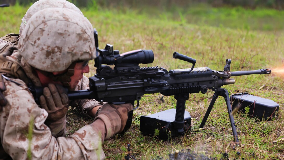 A Marine with 1st Battalion, 8th Marine Regiment fires the M249 Squad Automatic Weapon during a company sized combined-arms attack on range SR-9 at Marine corps Base Camp Lejeune, N.C., Sept. 24, 2015. During the training, Alpha Company fired the M4 carbine, the M16 A4 service rifle, M249 Squad Automatic Weapons, M240B machine guns, M2 .50 caliber heavy machine guns, MK19 40mm grenade launchers and M224 60mm lightweight mortar systems. 
