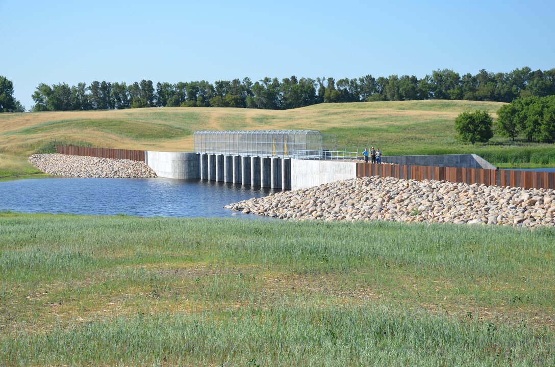 The St. Paul District celebrated the completion of the Tolna Coulee Advance Measures Project with a ribbon cutting ceremony July 19. The 800-foot wide structure is designed to regulate the amount of water that would flow through the coulee. Completion of this project significantly reduces the threat of catastrophic flooding along the Sheyenne River, if Stump Lake were to exceed 1,458 feet above sea level. According to the National Weather Service, the current lake level is 1,452.92 feet.