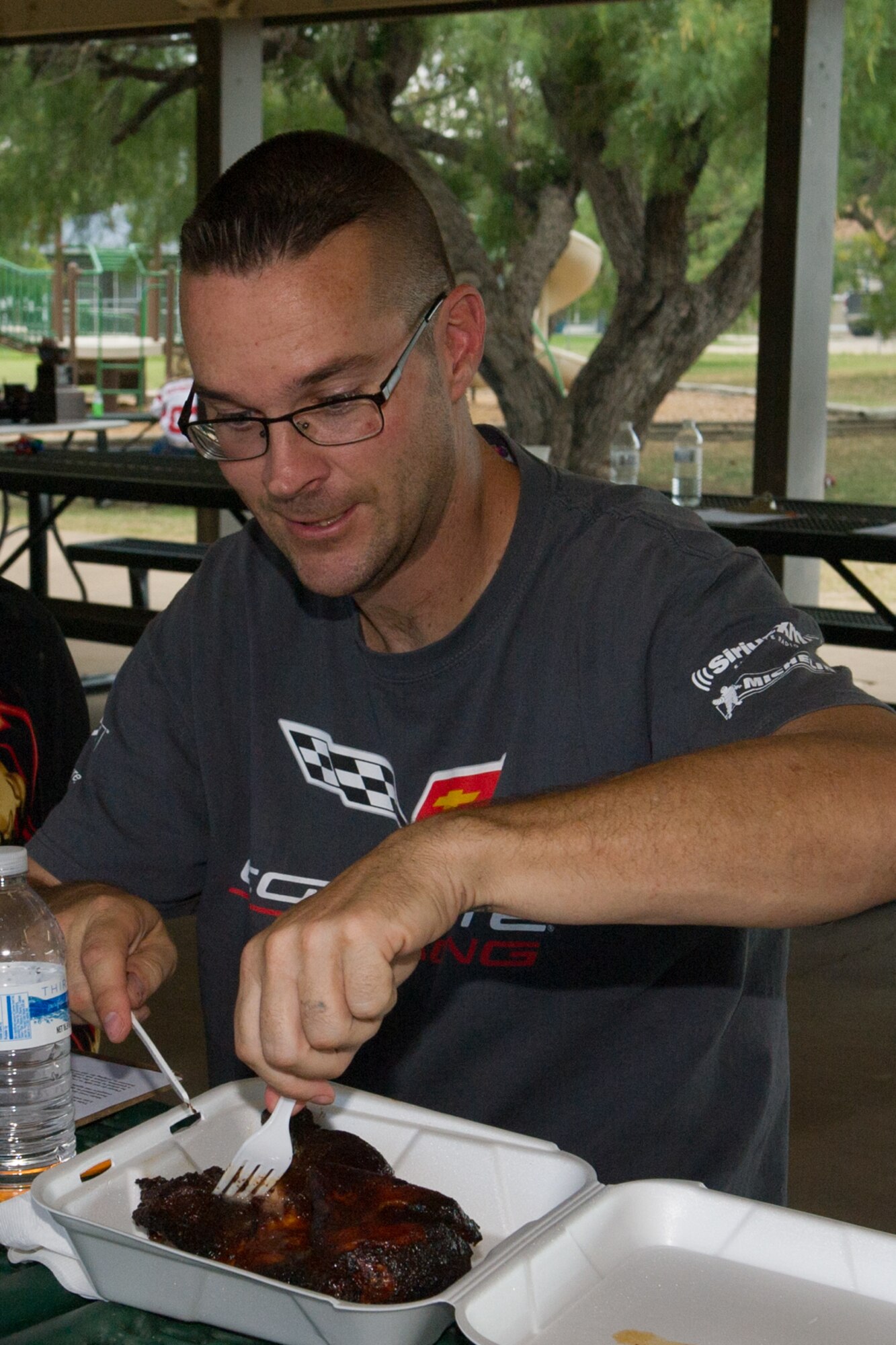 Neil R. Townley, 17th Training Wing Safety Office, cuts out a bite of chicken to judge during the 42nd Annual Armed Forces Chili Cook-off at the Goodfellow Recreation Camp, Goodfellow Air Force Base Recreation Camp, San Angelo, Texas, Sept. 26, 2015. Townley judged the “anything goes” chili, squadron chili, beans, chicken and brisket. (U.S. Air Force photo by Staff Sgt. Laura R. McFarlane/Released)