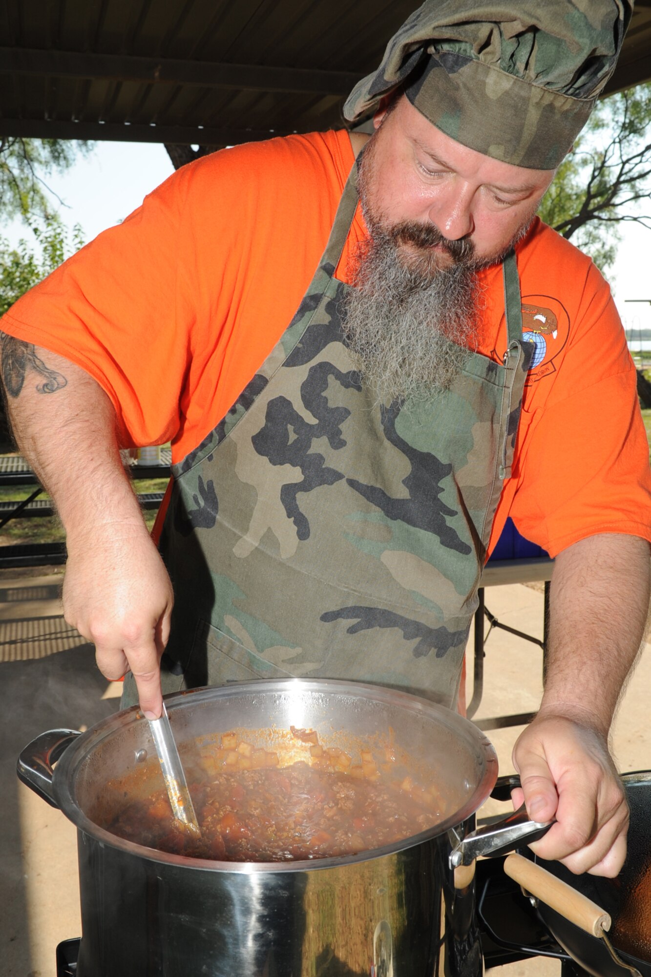 Russell E. Dunlap, 312th Training Squadron supply technician, stirs his team’s “anything goes” chili during the 42nd Annual Armed Forces Chili Cook-off at the Goodfellow Air Force Base Recreation Camp, San Angelo, Texas, Sept. 26, 2015. Dunlap competed in “anything goes” chili, squadron chili, representing the 17th Logistics Readiness Squadron, and People’s Choice Award, which his team took first place in. (U.S. Air Force photo by Staff Sgt. Laura R. McFarlane/Released)