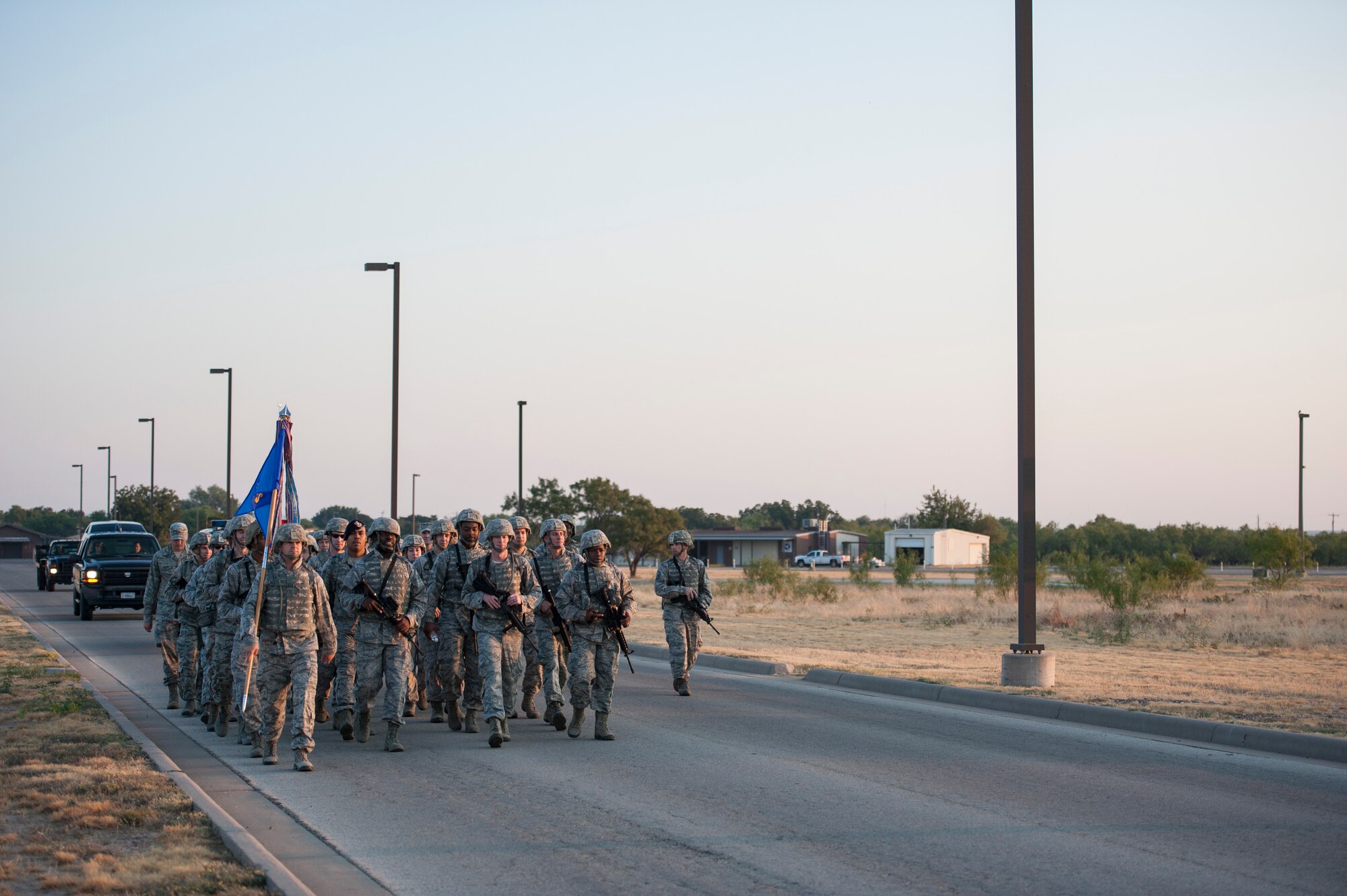 17th Training Wing members march up Apache Trail during the 10th Annual Airman 1st Class Jacobson Memorial Ruck March on Goodfellow Air Force Base, Texas, Sept. 29, 2015. The ruck march is hosted each year in honor of Jacobson who was the first female Airman to give her life in Operation Iraqi Freedom, as well as the first security forces member killed in combat since 1975. (U.S. Air Force photo by Staff Sgt. Michael Smith/Released)