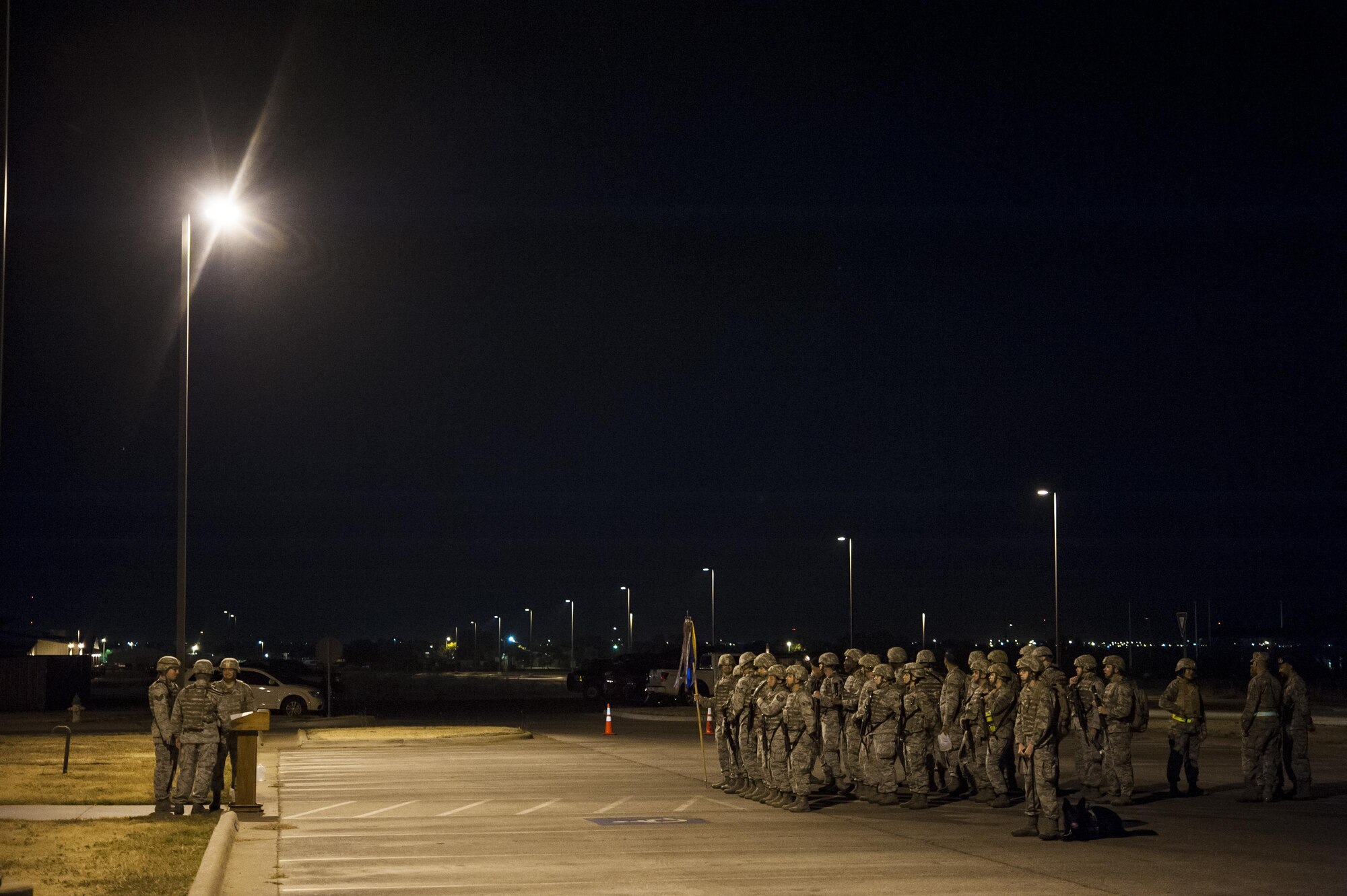 17th Training Wing members await the start of the 10th Annual Airman 1st Class Jacobson Memorial Ruck March at the 17th Security Forces Squadron building Sept. 28, 2015. The ruck march is hosted each year in honor of Jacobson who was the first female Airman to give her life in Operation Iraqi Freedom, as well as the first security forces member killed in combat since 1975. (U.S. Air Force photo by Staff Sgt. Michael Smith/Released)