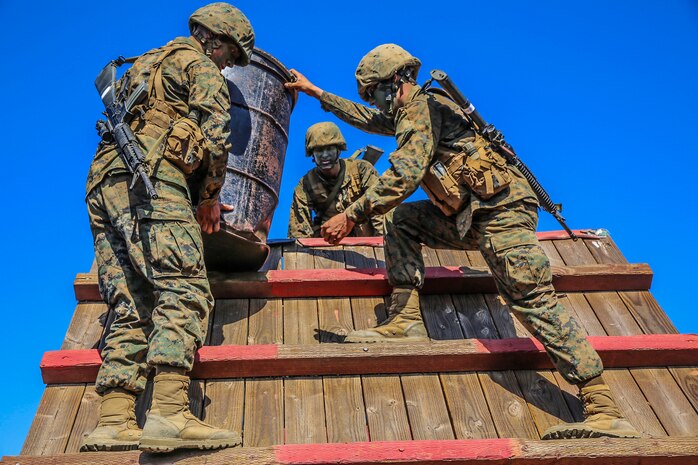 Recruits of Charlie Company, 1st Recruit Training Battalion, carry a barrel over a wall during the 12 Stalls event of the Crucible at Edson Range, Weapons and Field Training Battalion, Marine Corps Base Camp Pendleton, Calif., Sept. 23. For every task given, recruits were instructed to avoid the areas of the obstacles painted red. If the recruits or any part of their equipment touched the red areas, the squad was required to start the challenge over. Today, all males recruited from west of the Mississippi are trained at MCRD San Diego. The depot is responsible for training more than 16,000 recruits annually. Charlie Company is scheduled to graduate Oct. 2.