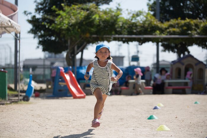 A preschooler from Kawashimo Preschool in Iwakuni, Yamaguchi Prefecture, Japan, scurries around the playground during a relay race at Kawashimo Preschool Sept. 29, 2015. Service members from Marine Corps Air Station Iwakuni visited the preschool to show their support and give back to the community.