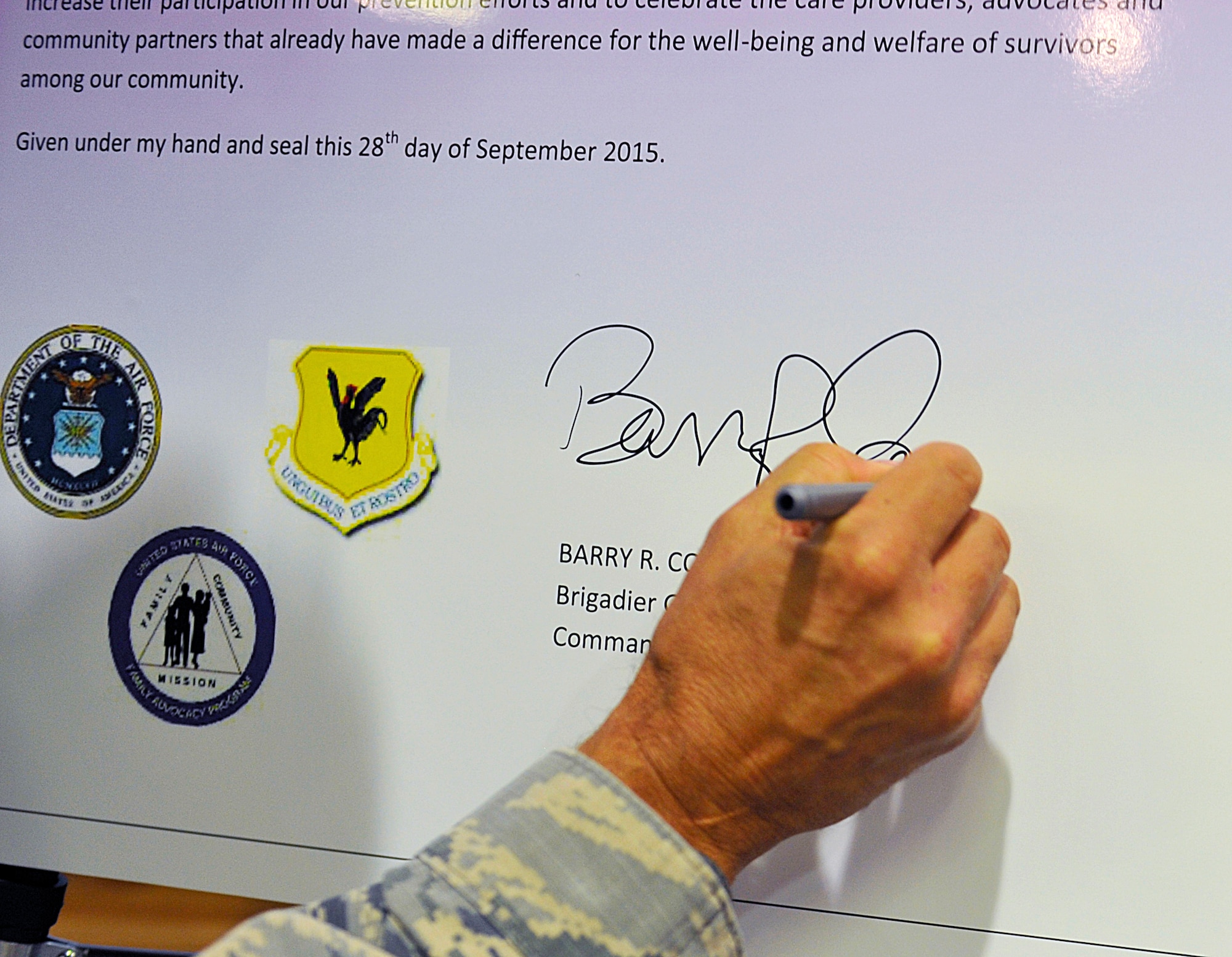 U.S. Air Force Brig. Gen. Barry Cornish, 18th Wing commander, signs a Domestic Violence Awareness and Prevention proclamation board Sept. 28, 2015, on Kadena Air Base, Japan. The focus of the campaign is to raise awareness of domestic violence, inform victims of help available and emphasize the negative impact domestic violence has on family readiness. (U.S. Air Force photo by Naoto Anazawa)

