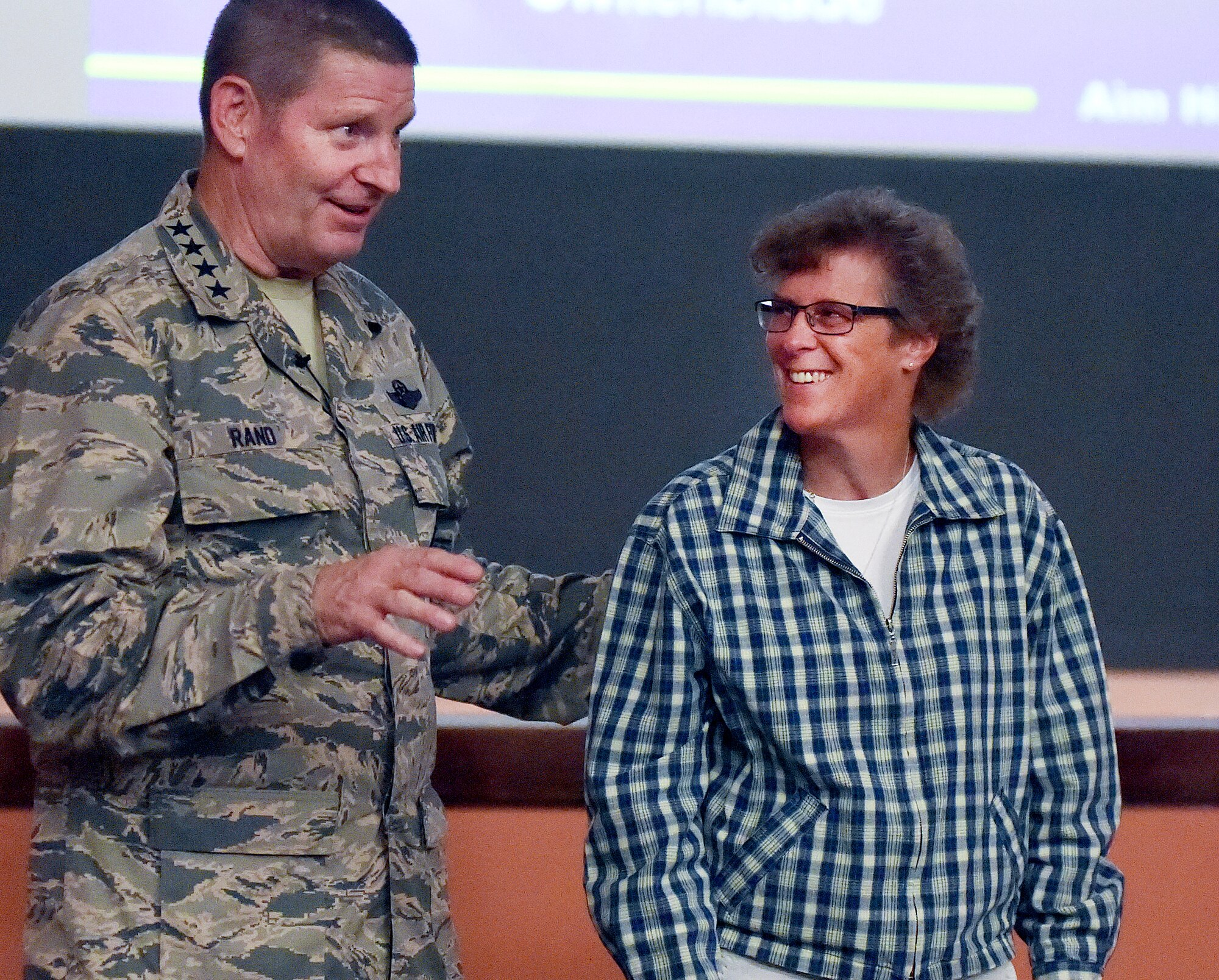 Gen. Robin Rand, AFGSC commander, recognizes Trudy Fralick, 90th Comptroller Squadron, during an all-call at F.E. Warren Air Force Base, Wyo., Sept. 23, 2015. Rand was on his first visit to the 20th Air Force and the 90th Missile Wing. (U.S. Air Force photo by R.J. Oriez)